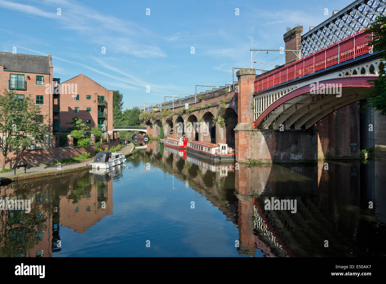 The Castlefield Urban Heritage Park and historic inner city canal conservation area including railway arches in Manchester, UK. Stock Photo