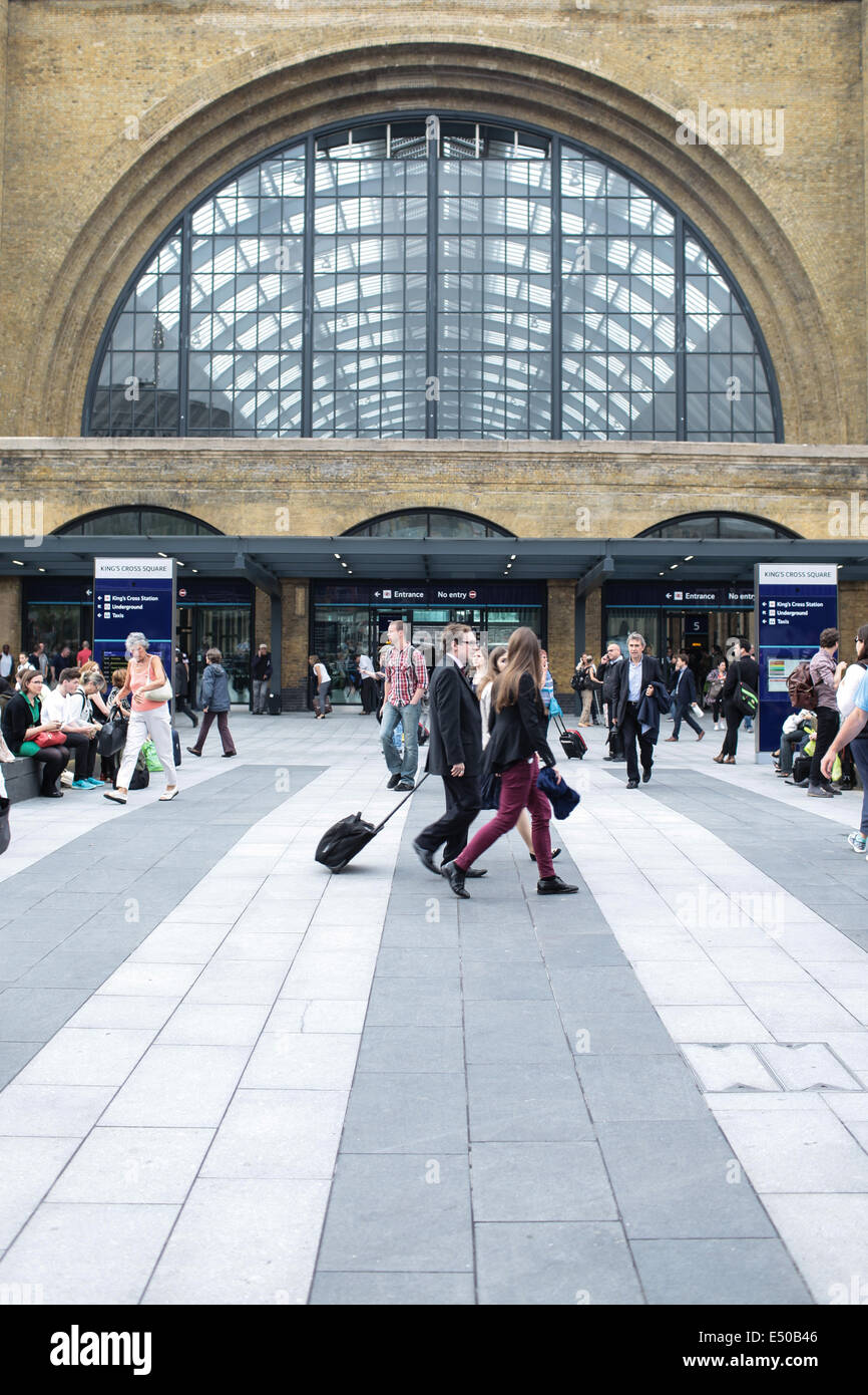 Commuters rush to catch a train at King's Cross railway station in London Stock Photo