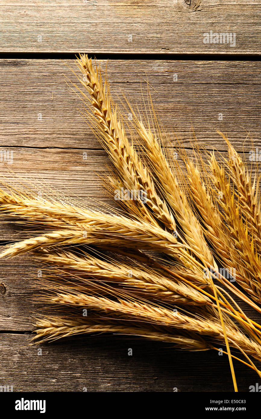 Rye spikelets over wooden background Stock Photo - Alamy