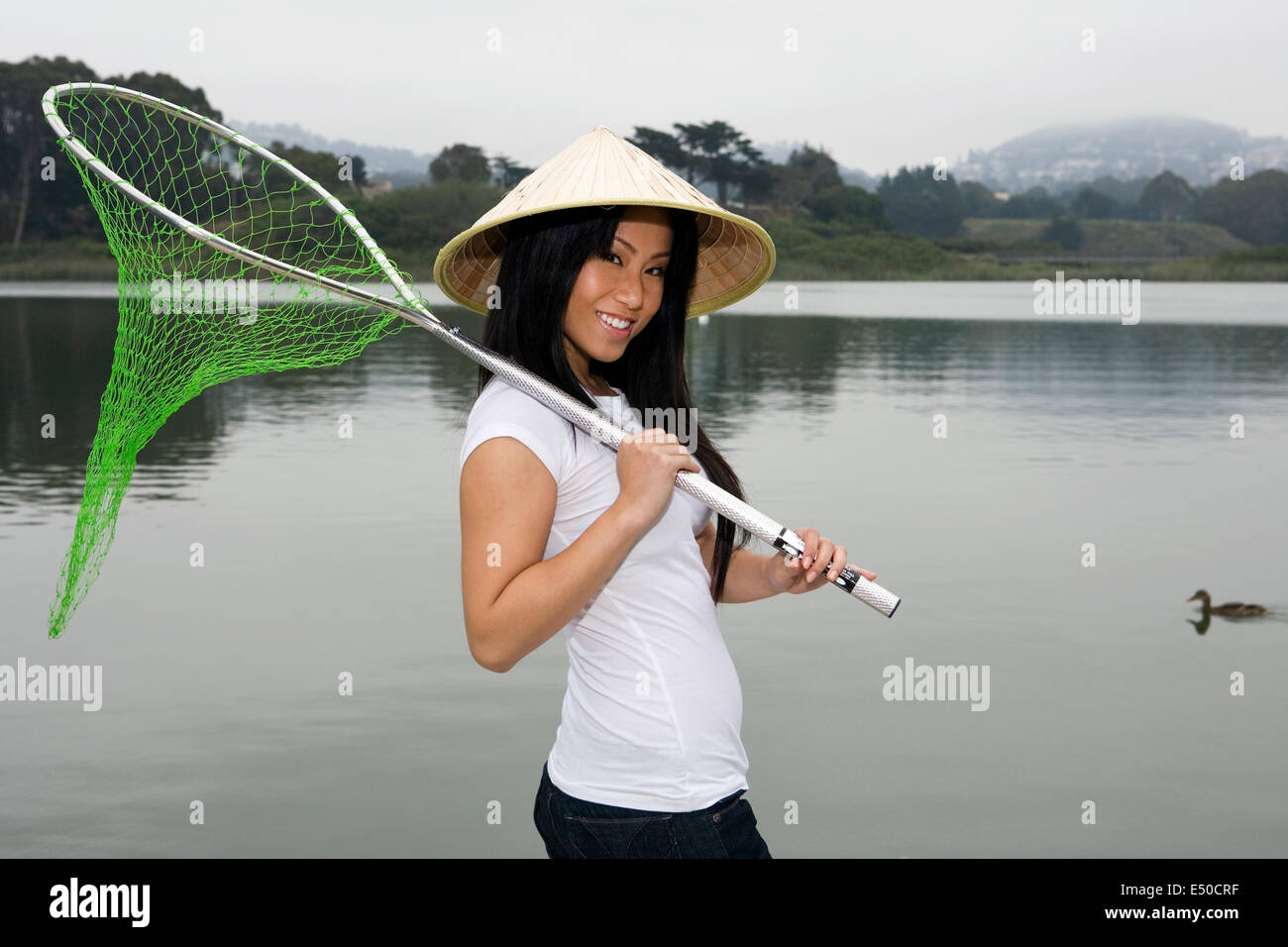 Beautiful woman holding fishing net hi-res stock photography and