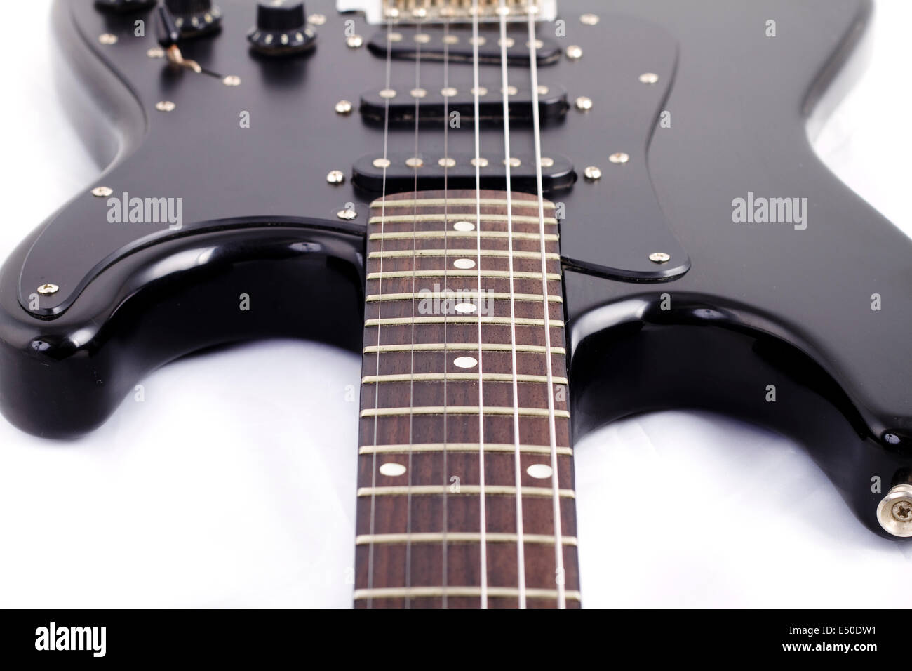 Black electric guitar on white background Stock Photo - Alamy