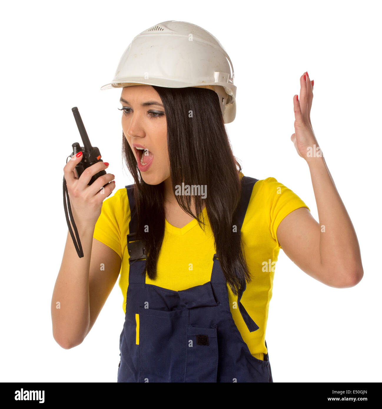 Angry worker looking to walkie-talky Stock Photo