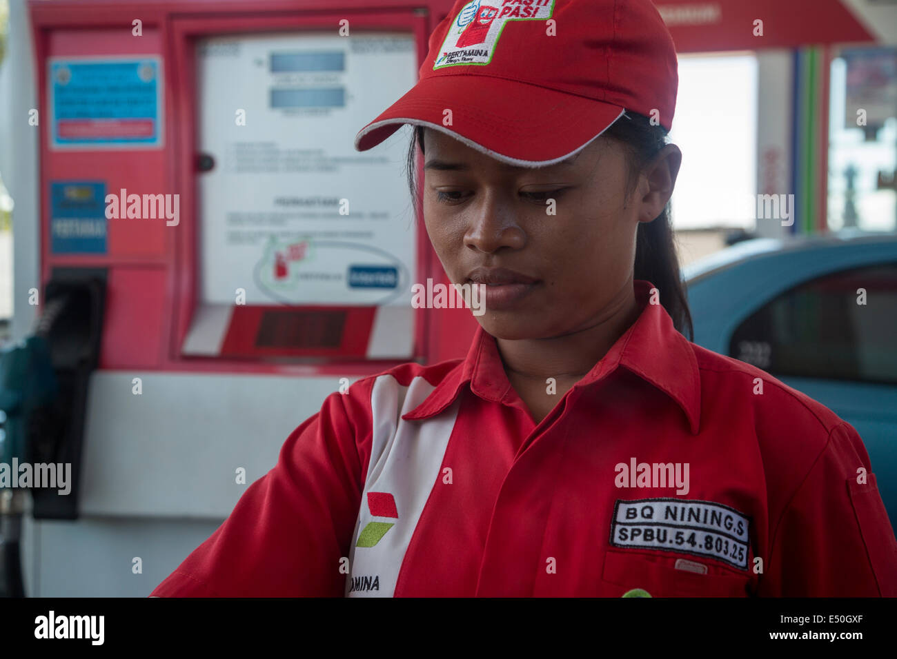 Bali, Indonesia.  Young Balinese Female Gas Station Attendant. Stock Photo