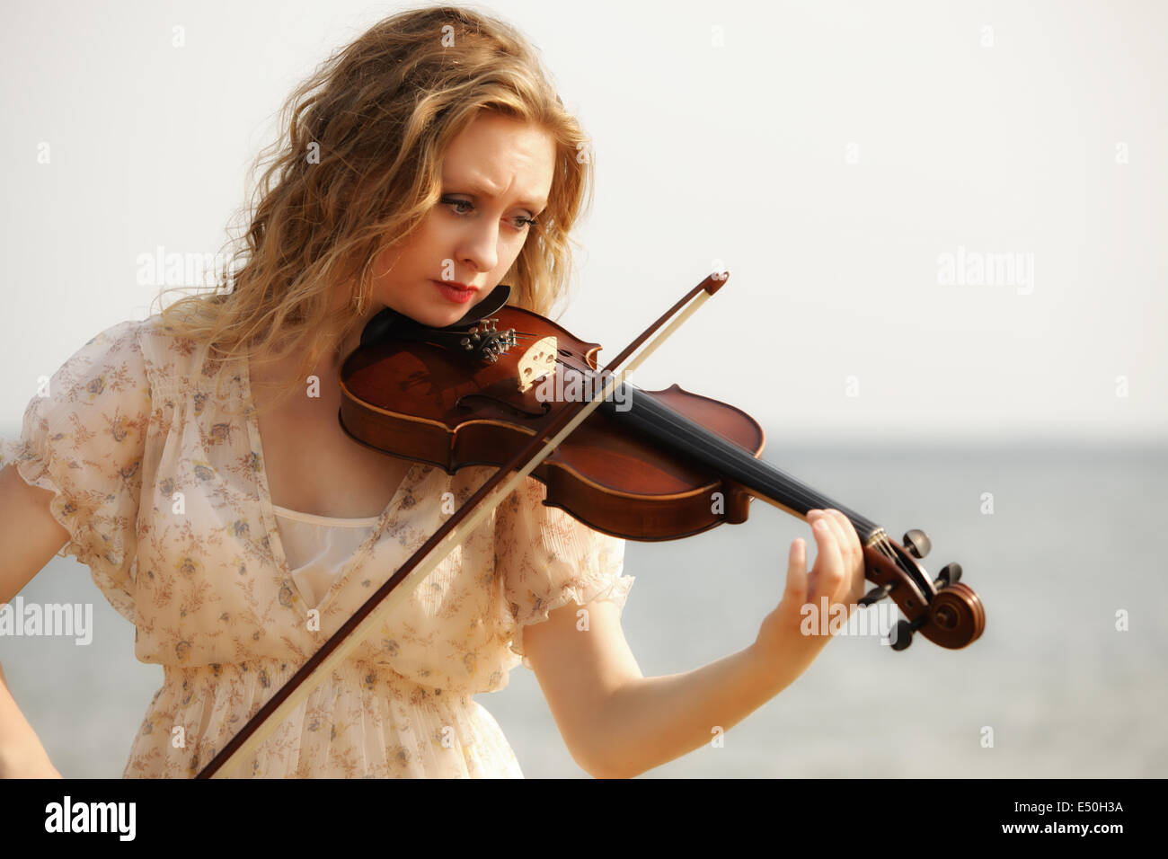 Portrait blonde girl with a violin outdoor Stock Photo - Alamy