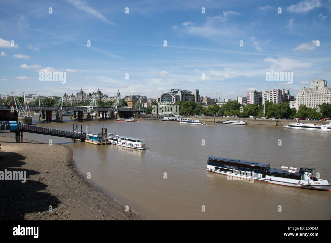 River Thames looking towards Festival Pier and Charing Cross station on the Embankment from Waterloo Bridge London UK Stock Photo