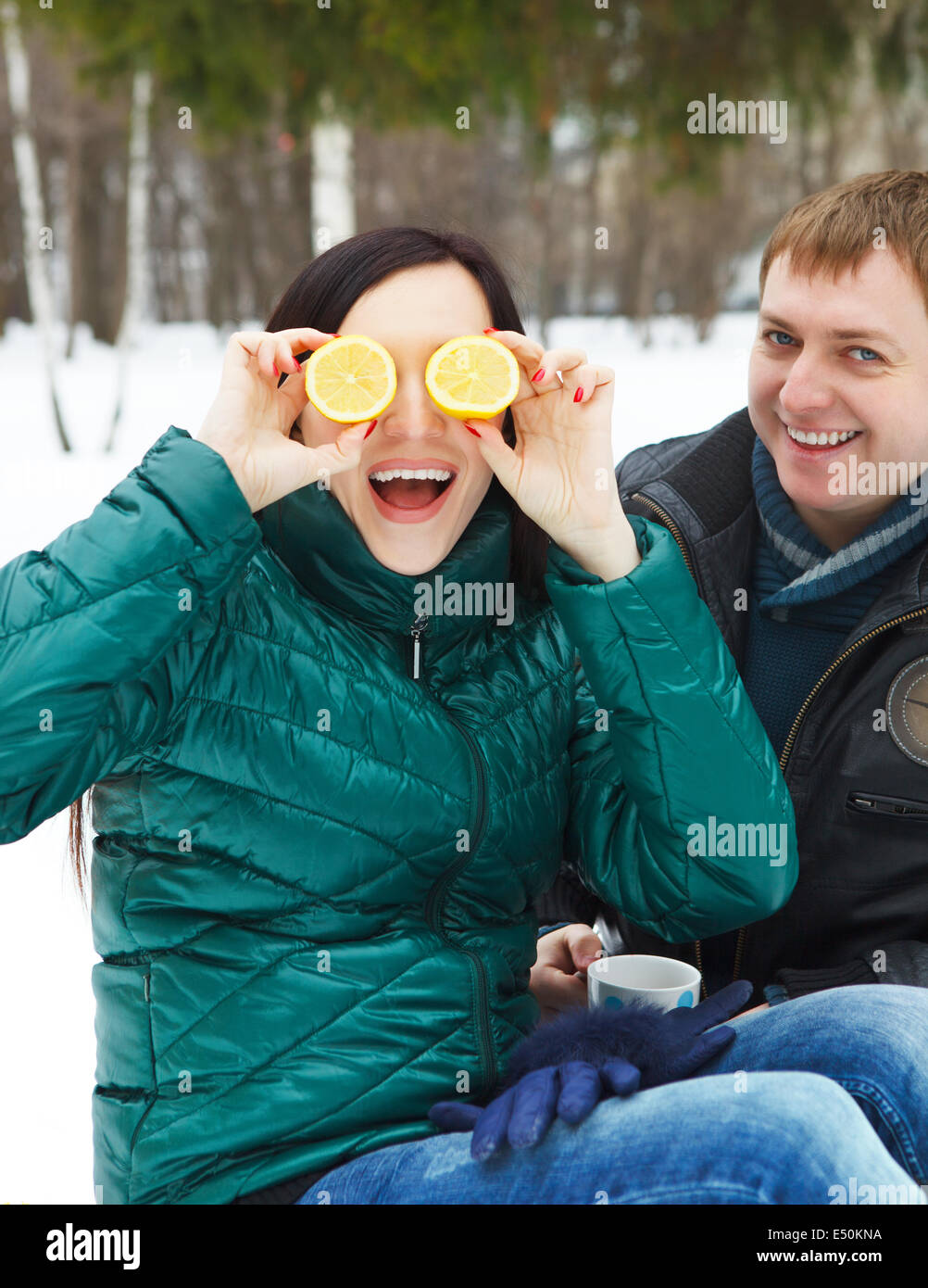 Happy young couple in the winter park Stock Photo - Alamy