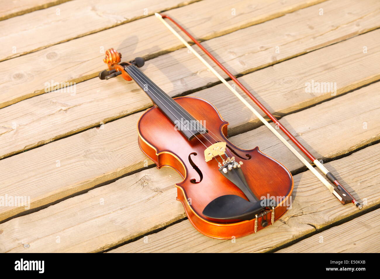 Violin on sandy beach. Music concept Stock Photo
