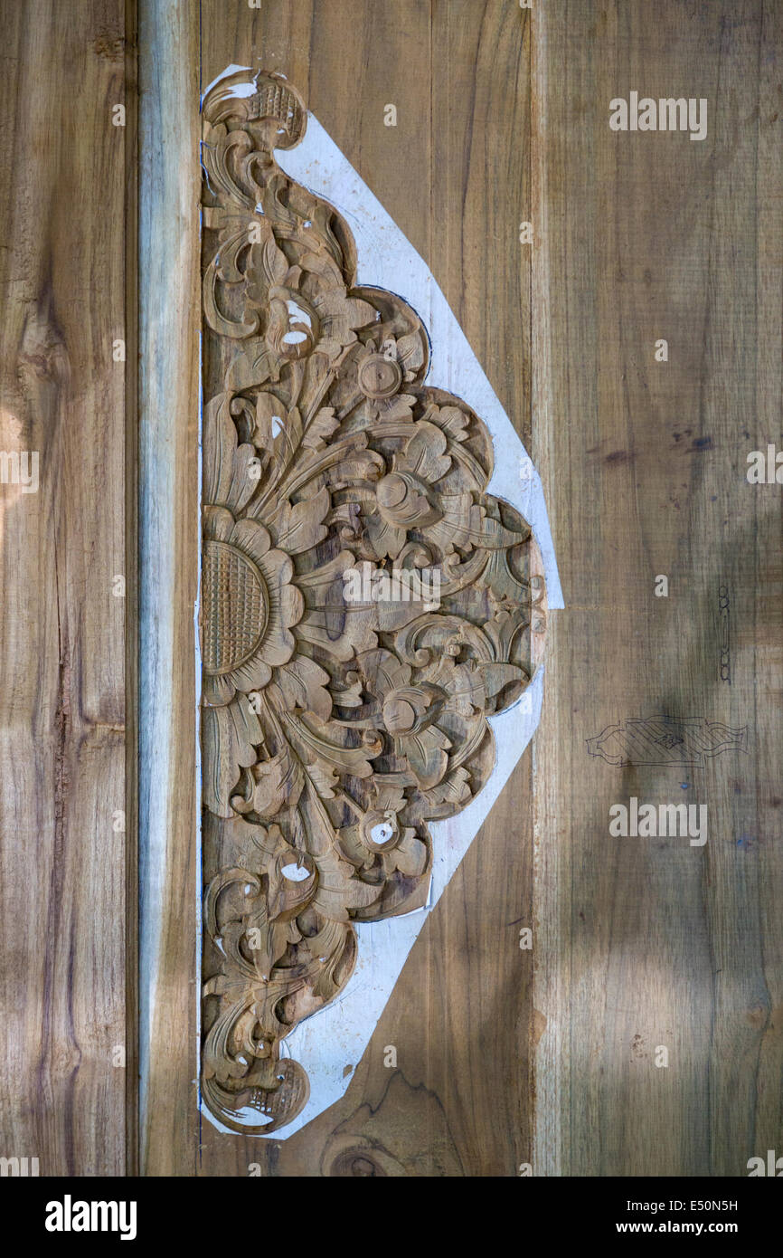 Bali, Indonesia.  Decorative Design Carved in Door, Remnants of Design Template Still in Place. Stock Photo