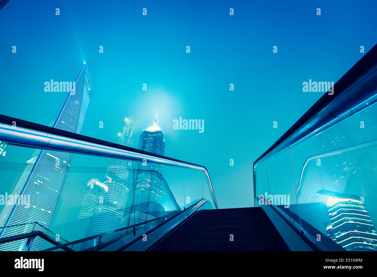 escalator and shanghai skyline at night Stock Photo