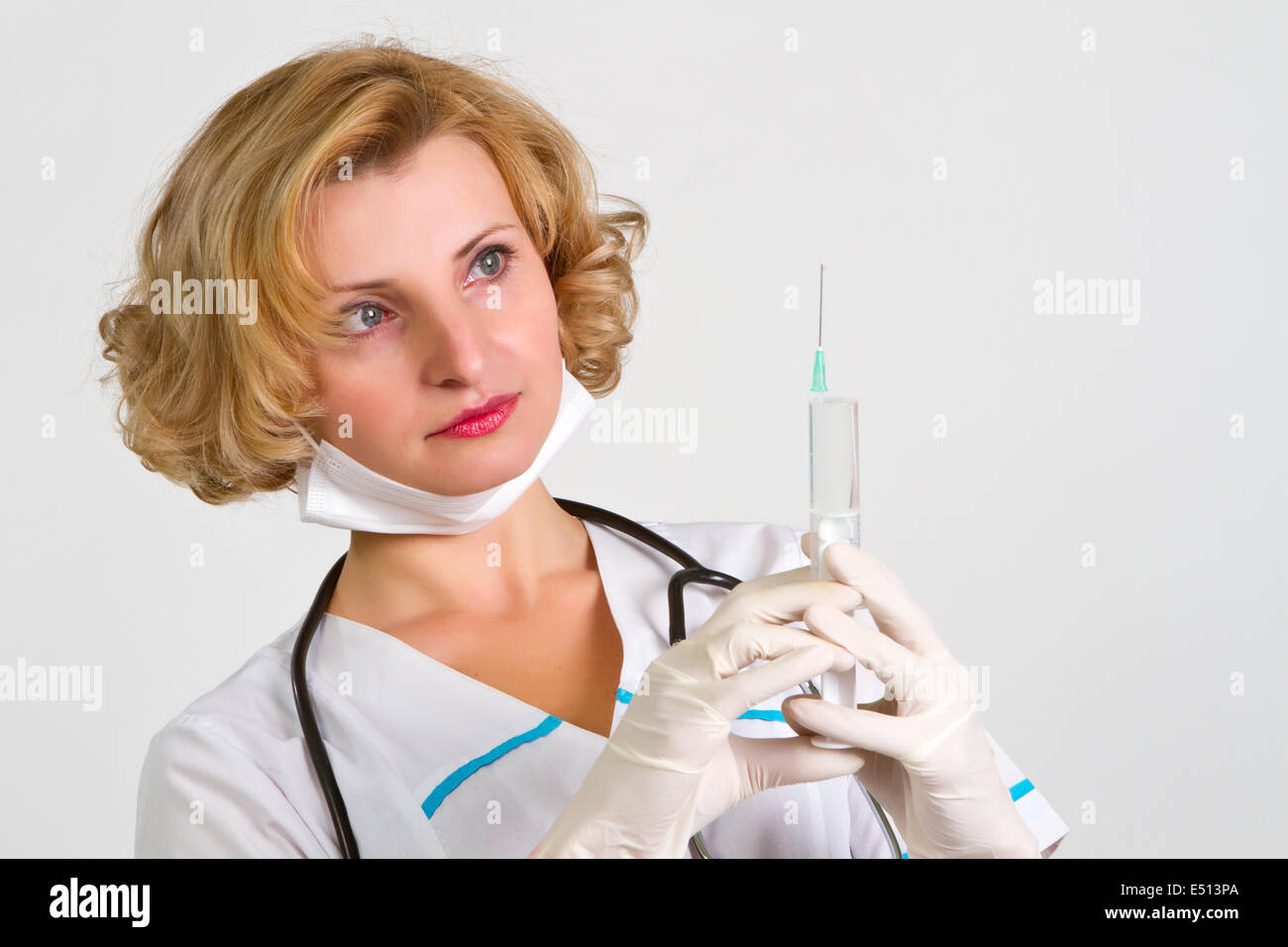 beautiful doctor  in gloves showing ampule Stock Photo