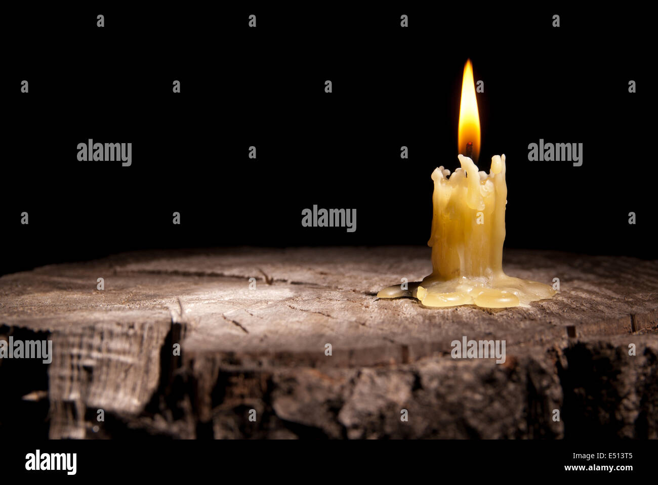 old candle on the black background Stock Photo - Alamy