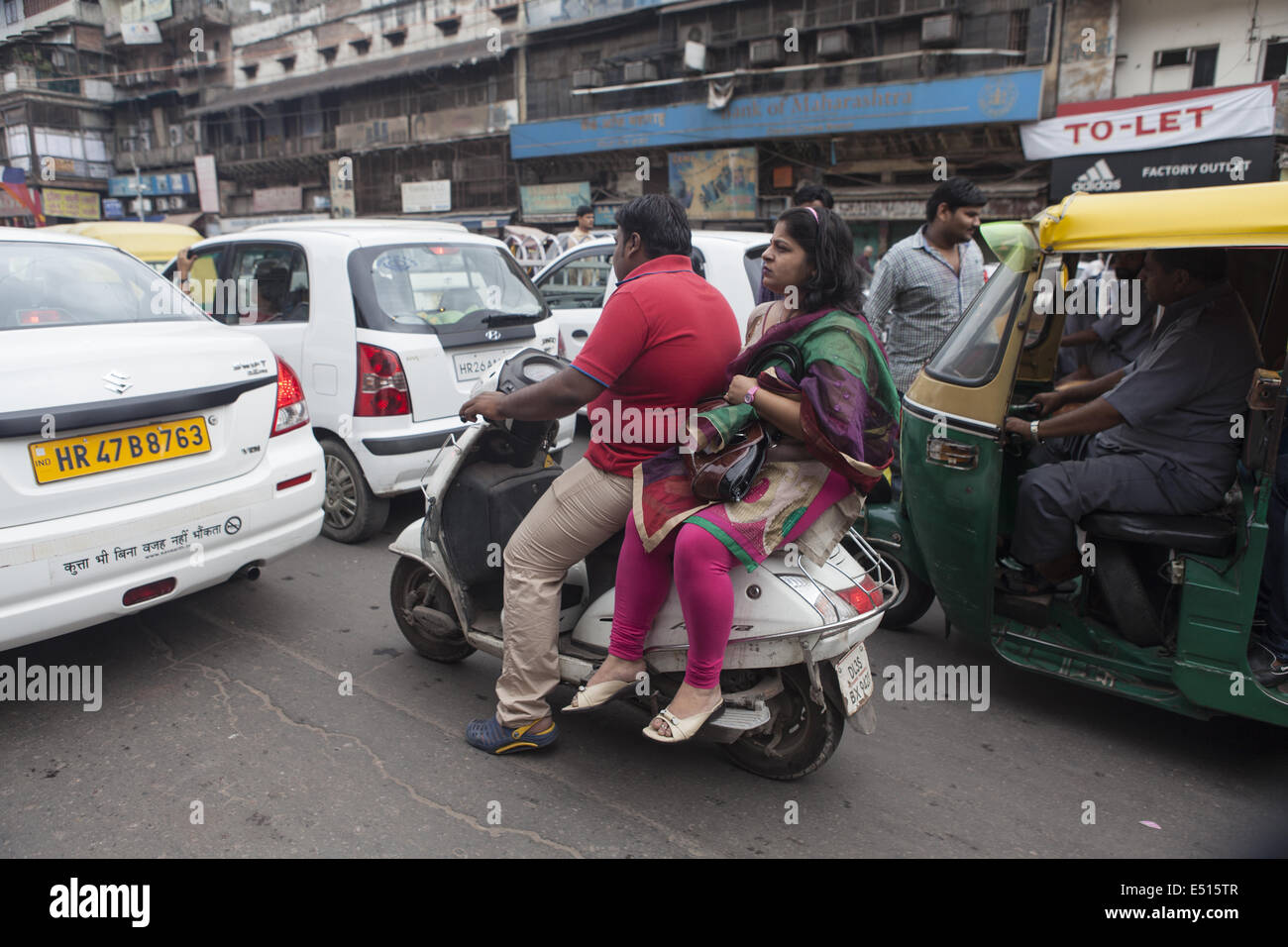 Couple driving scooter in Old-Dehli, India Stock Photo