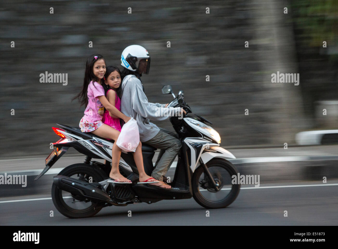 Bali, Indonesia.  Woman and Girls on Motor Bike, Klungkung, Semarapura. Stock Photo