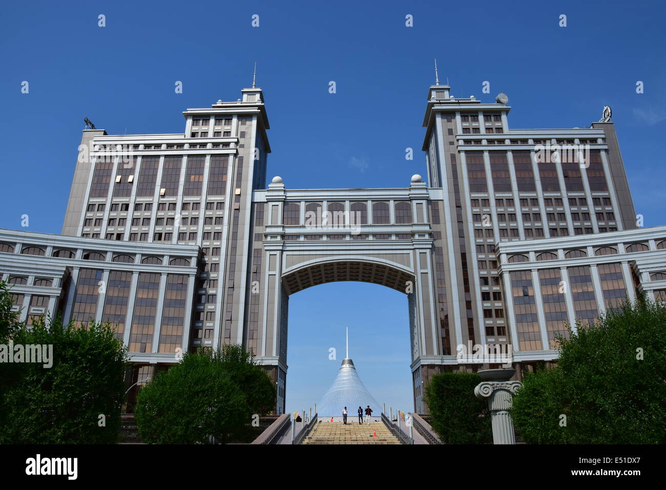 A city view of Astana / Kazakhstan with the KazMunaiGaz building and the Khan Shatyr cupola visible through the arch Stock Photo
