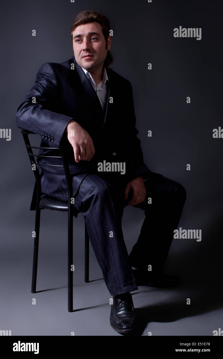 portrait of a young man in a black suit Stock Photo - Alamy