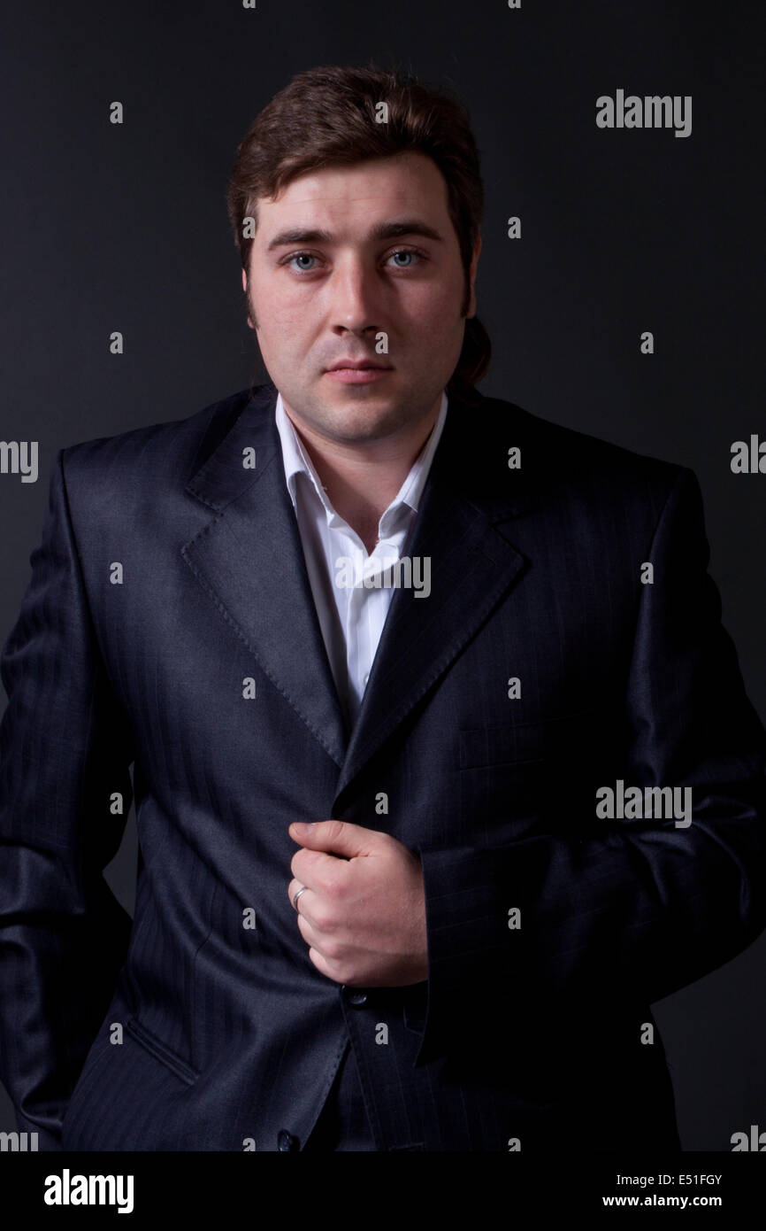 portrait of a young man in a black suit Stock Photo
