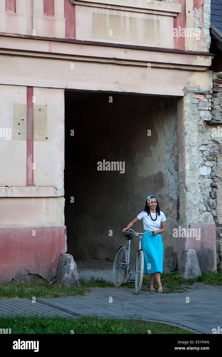 Retro girl on old bike Stock Photo