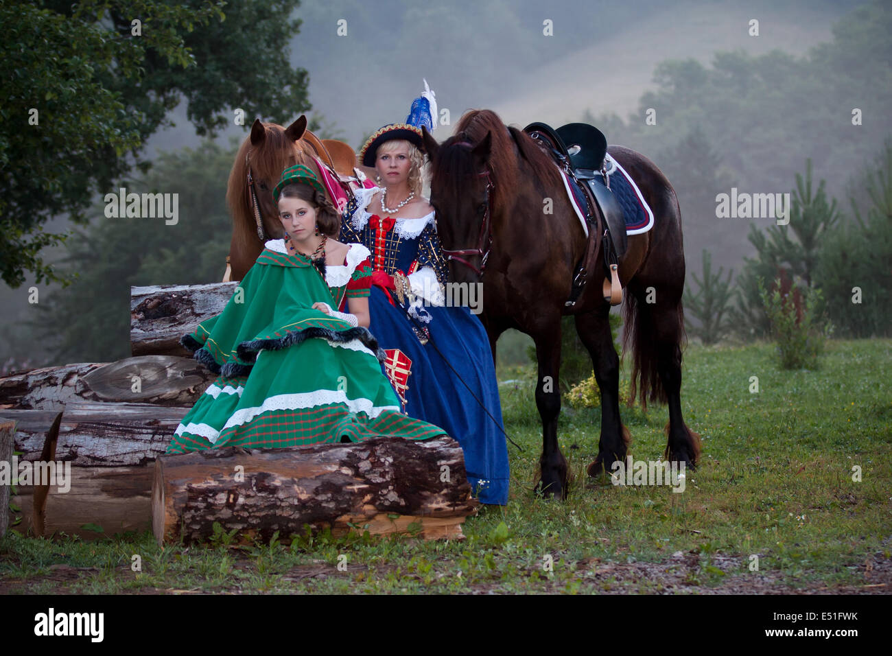 Two women in the royal baroque dress riding Stock Photo - Alamy