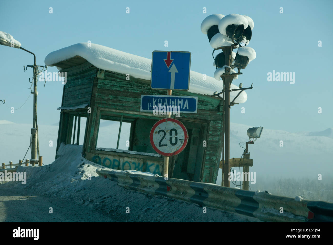 Snow covered wooden Russian signal box road signs Stock Photo