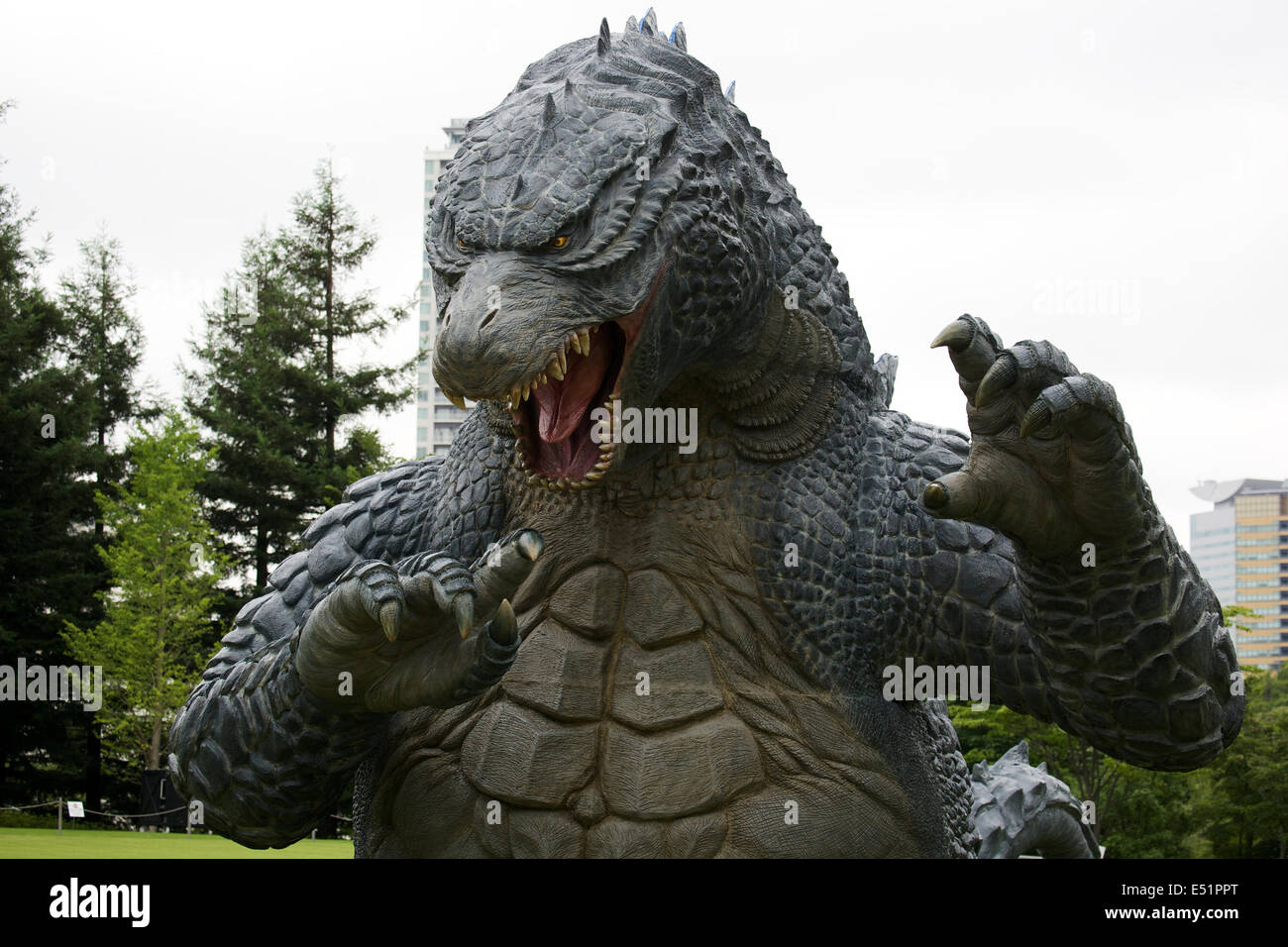 Tokyo, Japan. 18th July, 2014. A 6.6 meter model of the new Godzilla is displayed at Tokyo Midtown on July 18, 2014, Tokyo. The statue is a 1/7 scale reproduction of the 180 meters tall Hollywood film version of 'GODZILLA'. Godzilla and its footprints will be displayed from July 18 to August 31 during which time it will perform a special show using mist, light and sound effects every 30 minutes between 19:00 to 21:00. Credit:  Rodrigo Reyes Marin/AFLO/Alamy Live News Stock Photo