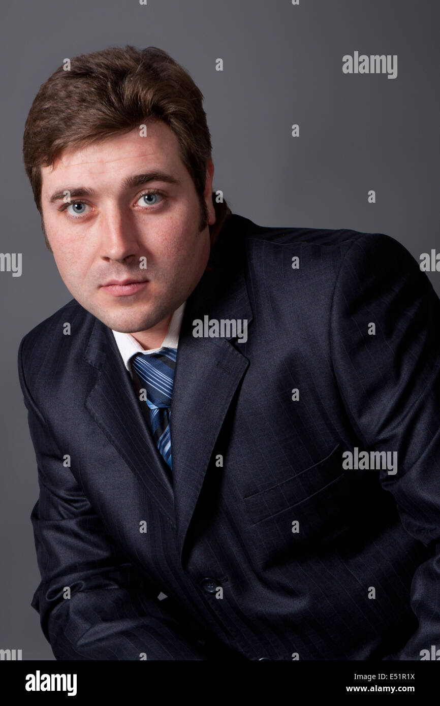 young man in a black suit Stock Photo