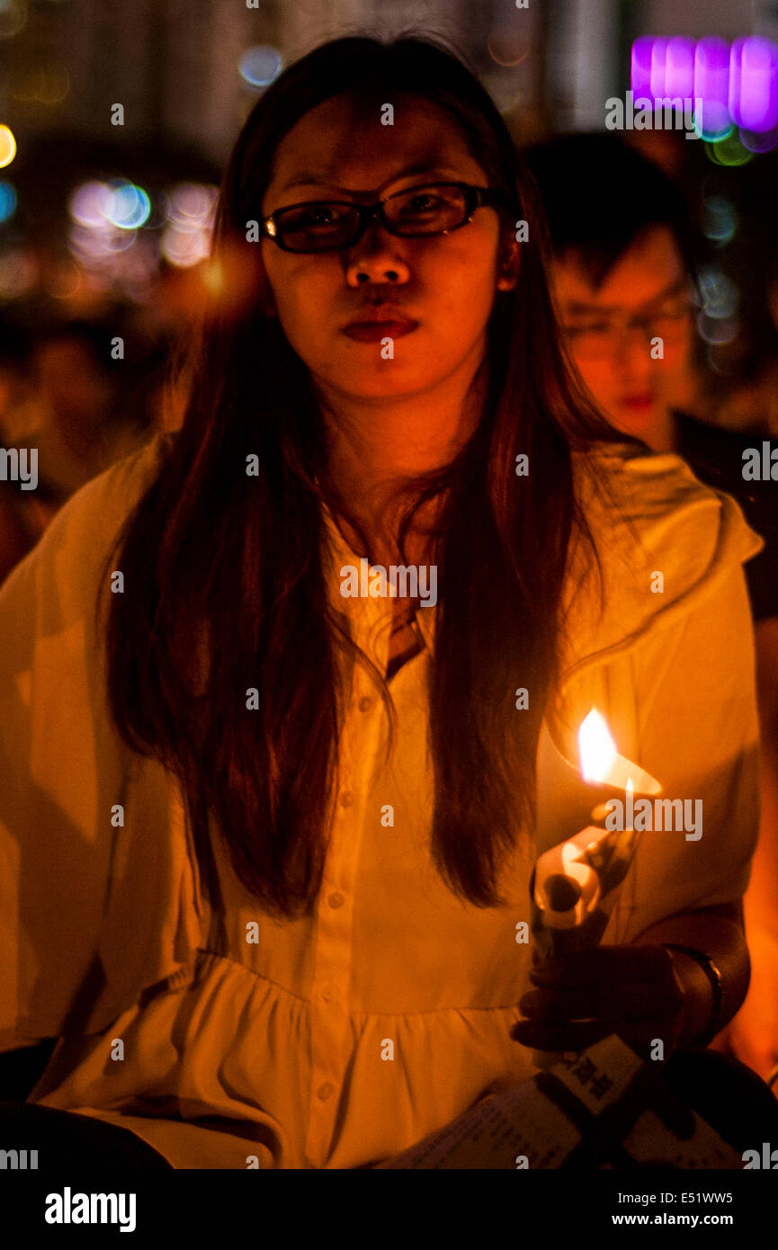 A demonstrator holds a candle in memorial for the people shot at Tiananmen Square in 1989 during its 25th anniversary Stock Photo