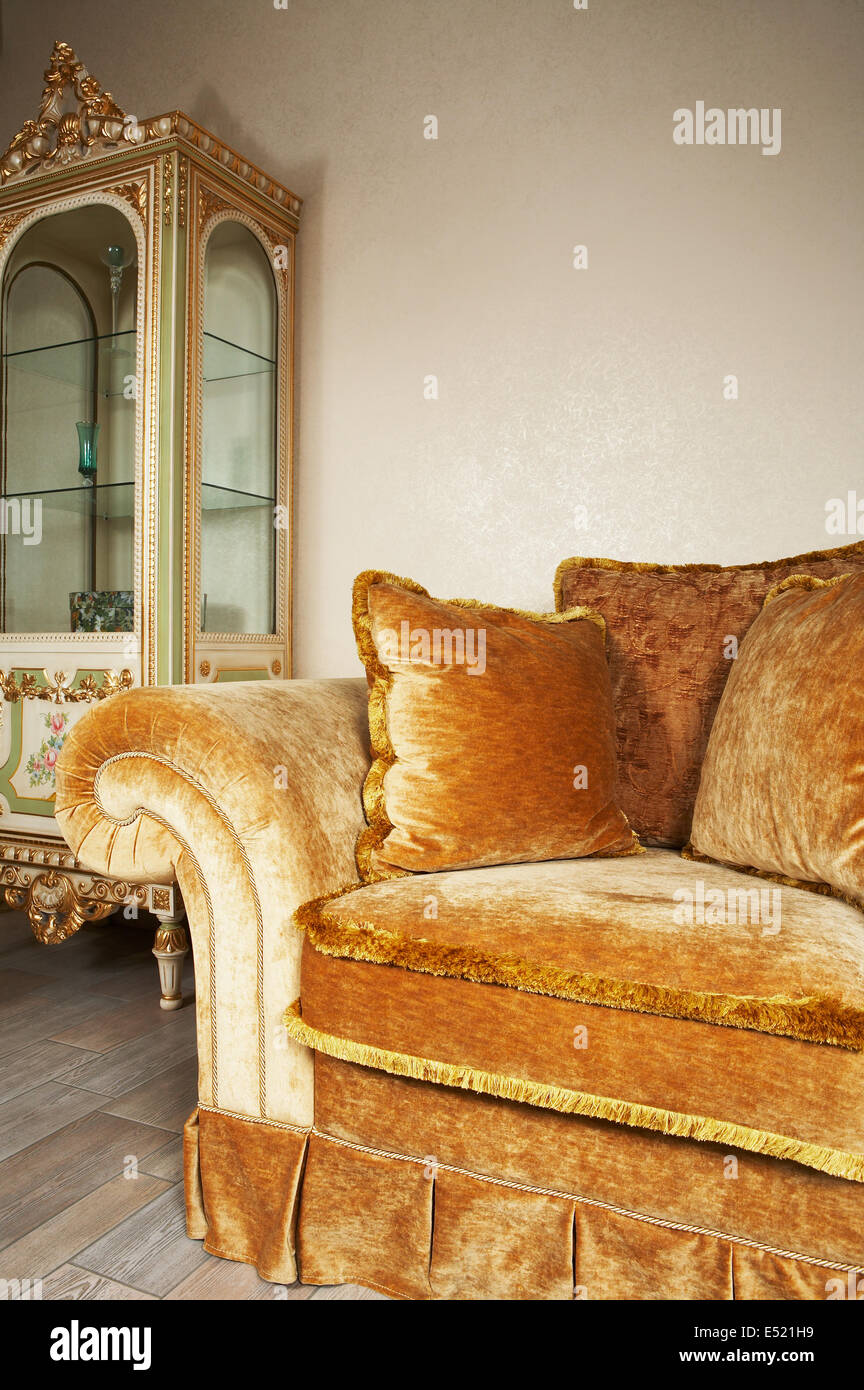 Orange sofa with pillows Stock Photo - Alamy