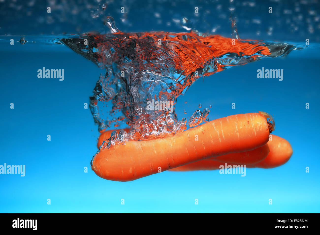 Carrot in the water splash over blue Stock Photo Alamy