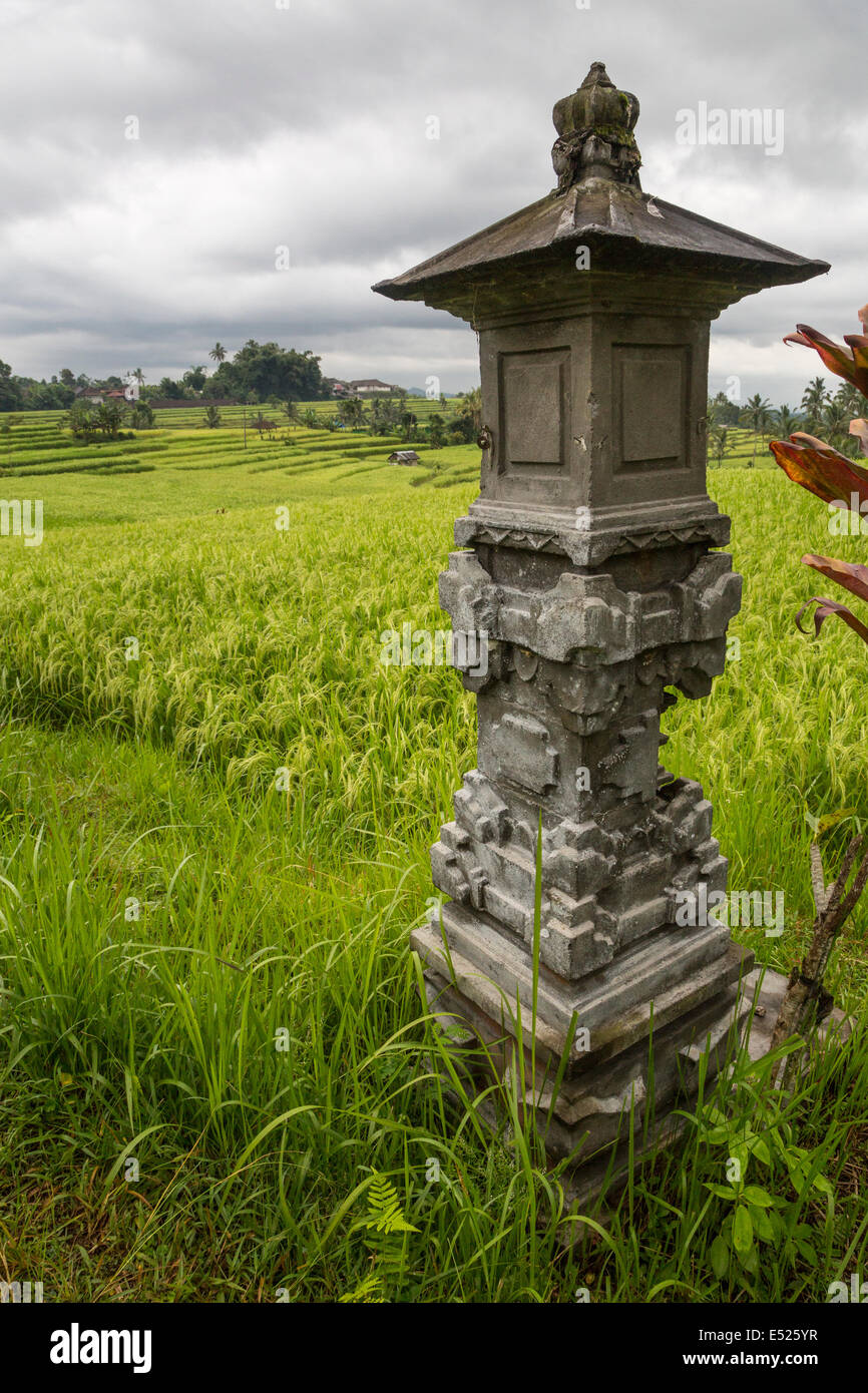 Jatiluwih, Bali, Indonesia.  Shrine to the Rice Goddess Sri.  Terraced Rice Paddies in the Distance. Stock Photo