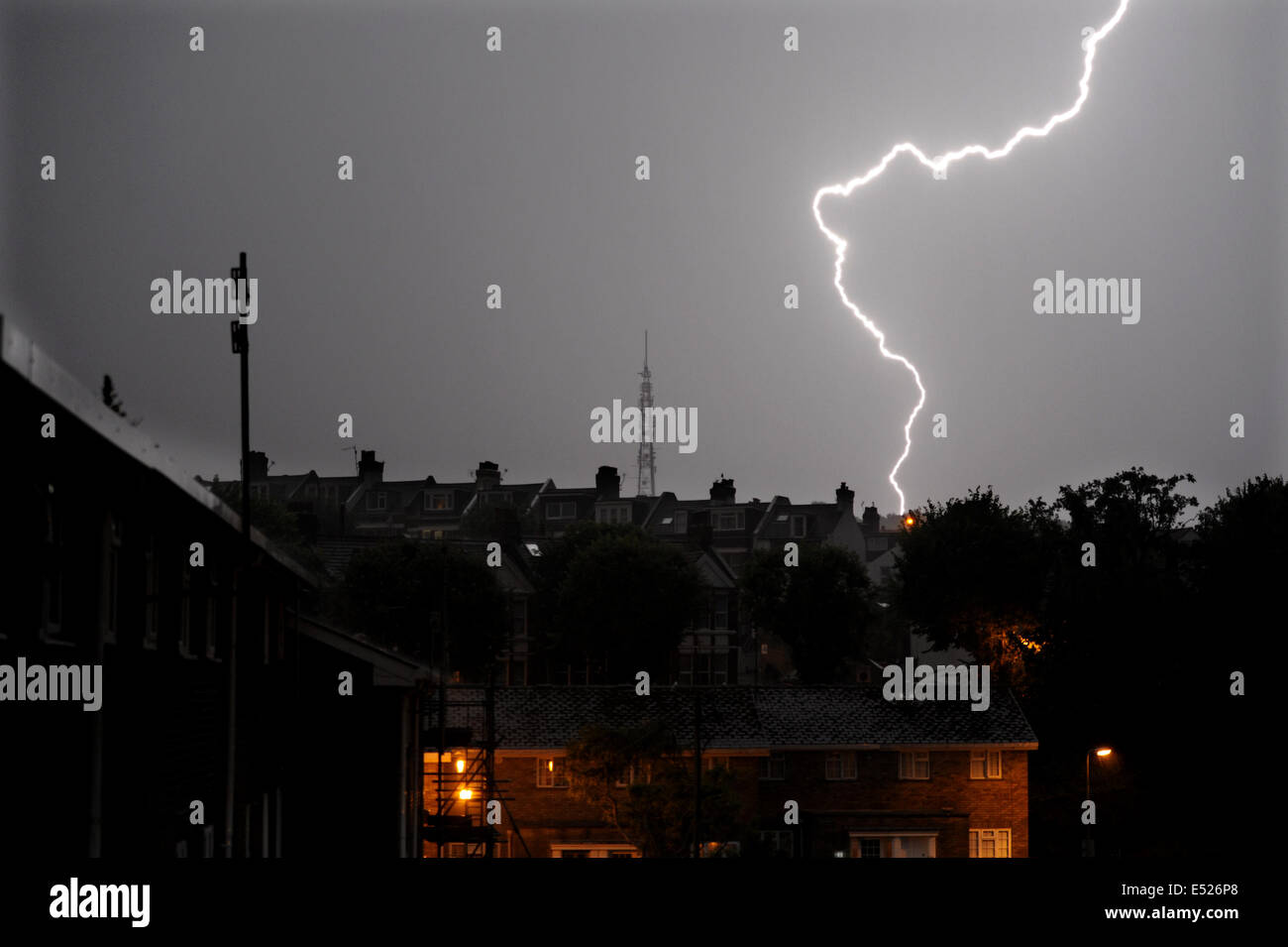 Brighton, Sussex, UK. 18th July, 2014.  Weather, A fork of lightning lights up the sky near the Whitehawk Hill Transmitting Station aerial in Brighton just after 2am in the morning during violent thunder storms which swept the south east of Britain  Credit:  Simon Dack/Alamy Live News Stock Photo