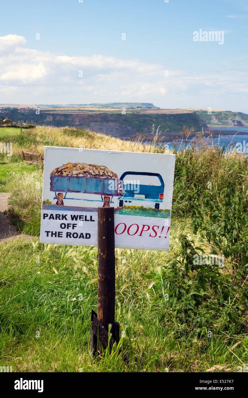 Warning sign advising drivers to park well off the road to avoid damage by passing wide agricultural vehicles Stock Photo