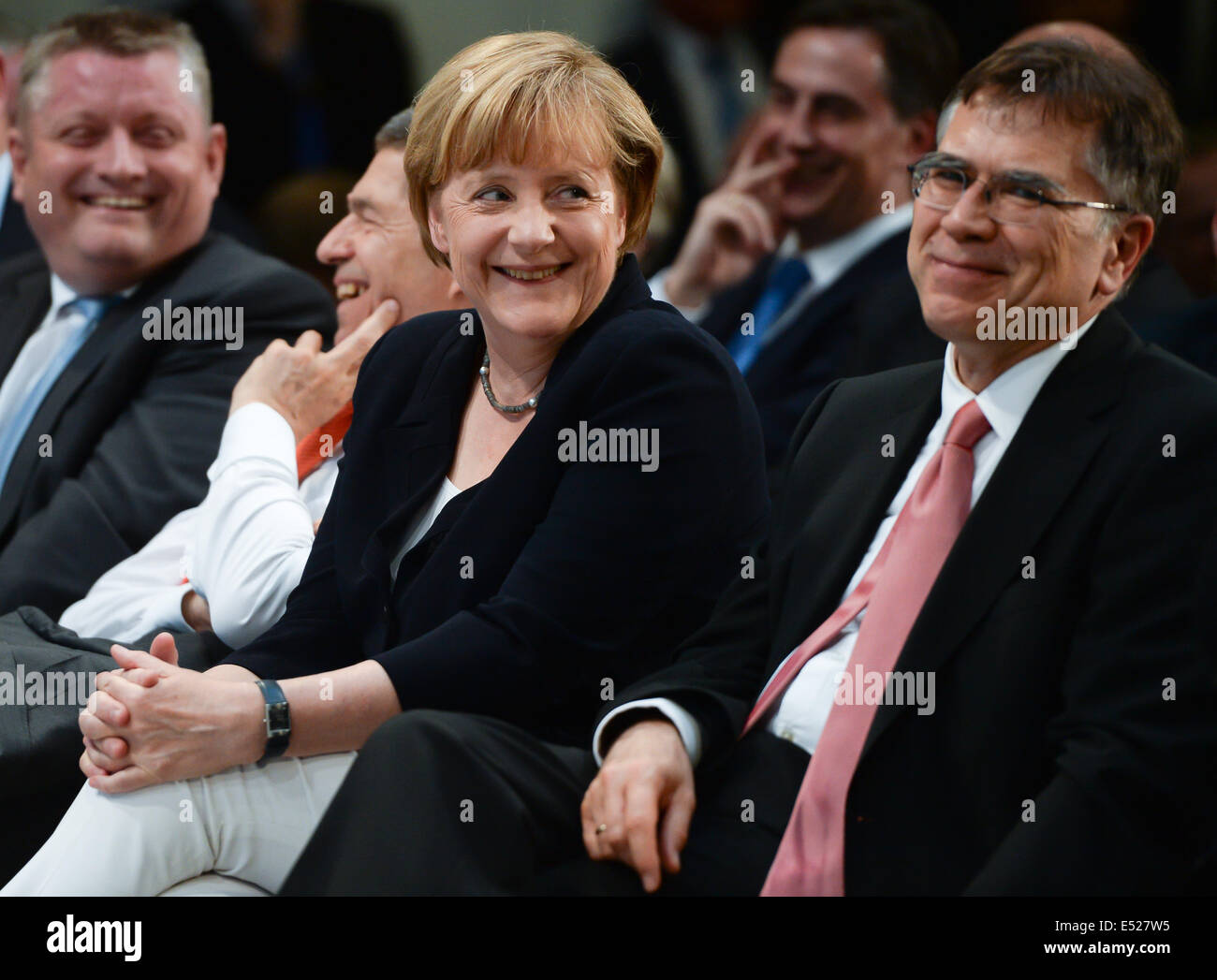 German Chancellor Angela Merkel smiles next to German Health Minister Hermann Groehe (L-R), her husband Joachim Sauer and historian Juergen Osterhammel during the party for her 60th birthday in Berlin, Germany, 17 July 2014. Around 1,000 guests were invited to the event at Konrad-Adenauer-Haus in Berlin. Photo: SOEREN STACHE/dpa Stock Photo