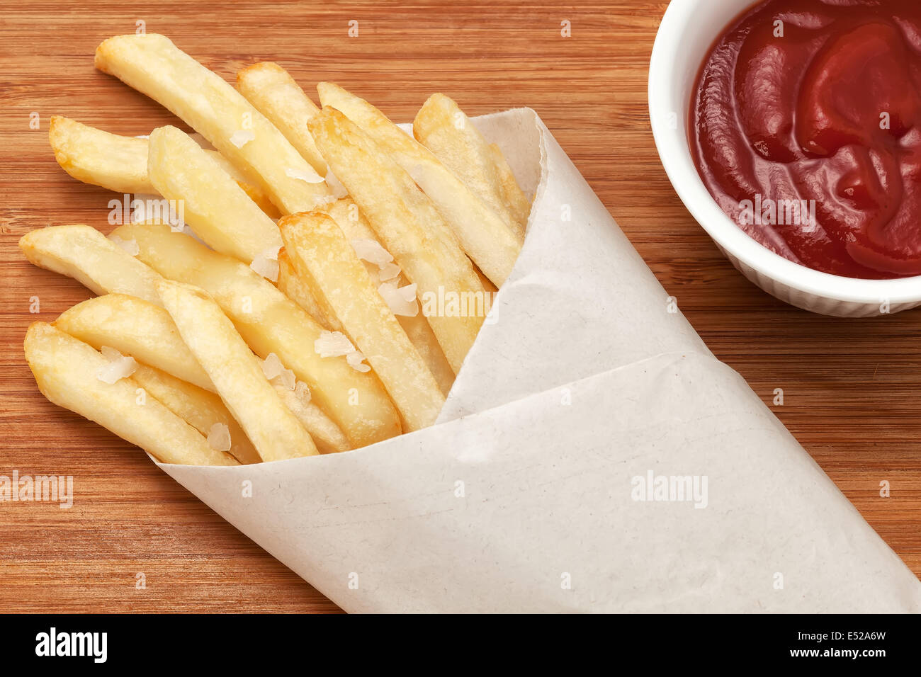 French fries in wrapping paper with ketchup Stock Photo Alamy