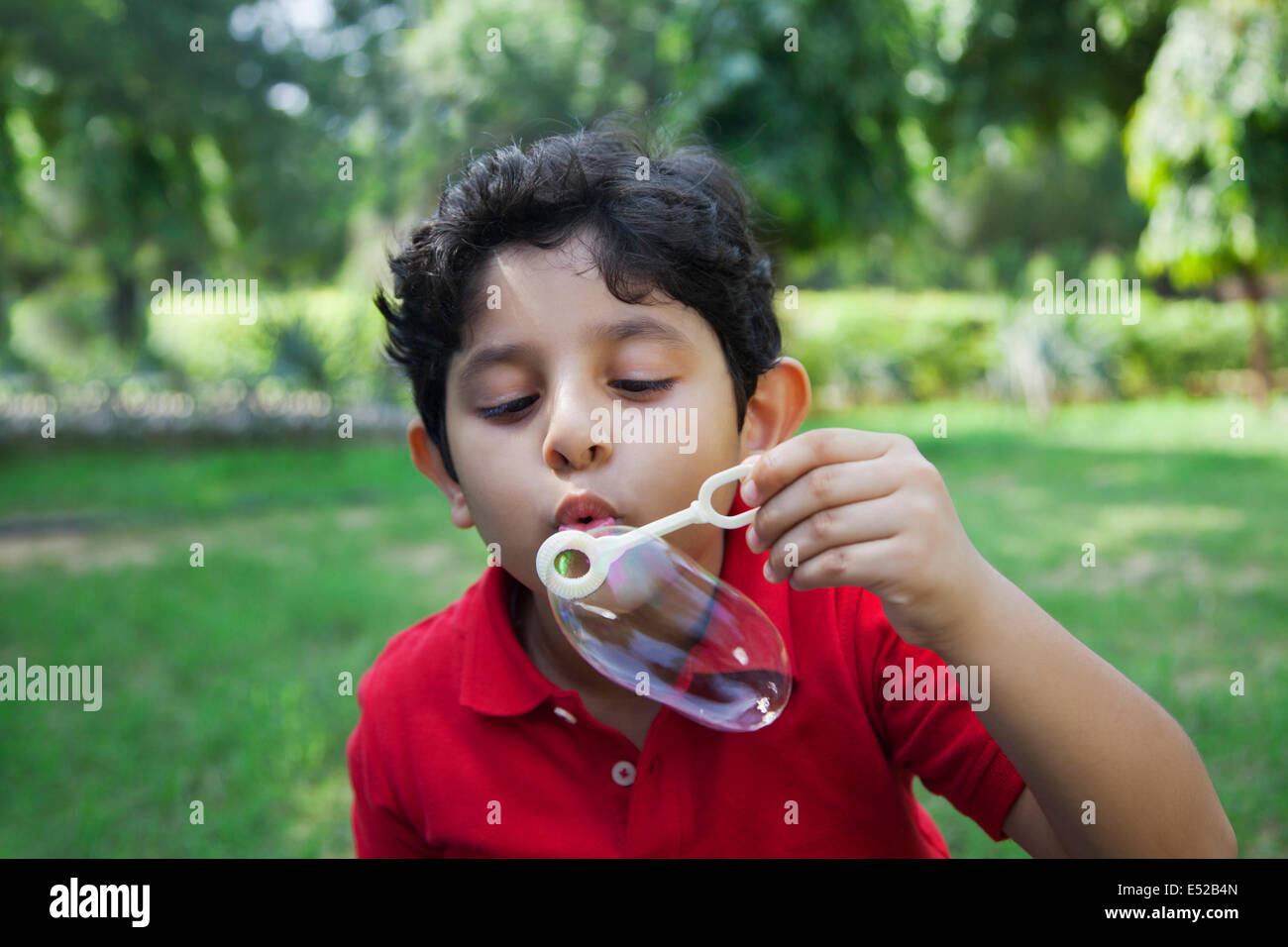 Young boy blowing bubbles Stock Photo