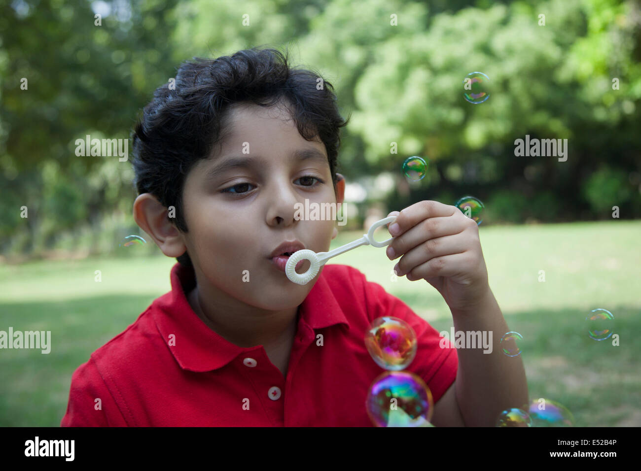 Young boy blowing bubbles Stock Photo