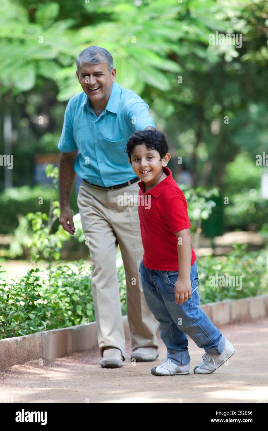 Grandfather and grandson taking a walk in a park Stock Photo