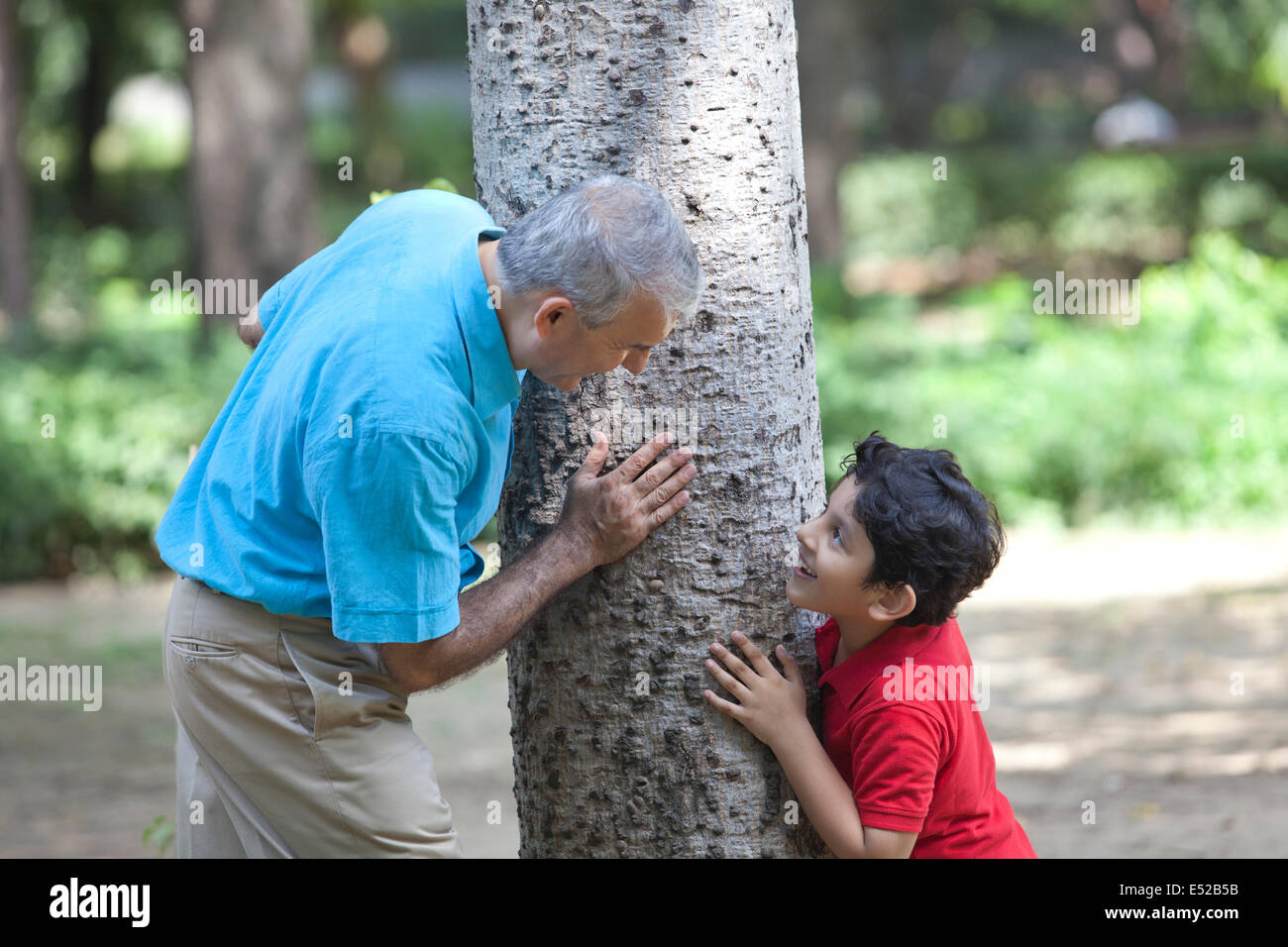 Grandfather and grandson playing hide and seek Stock Photo