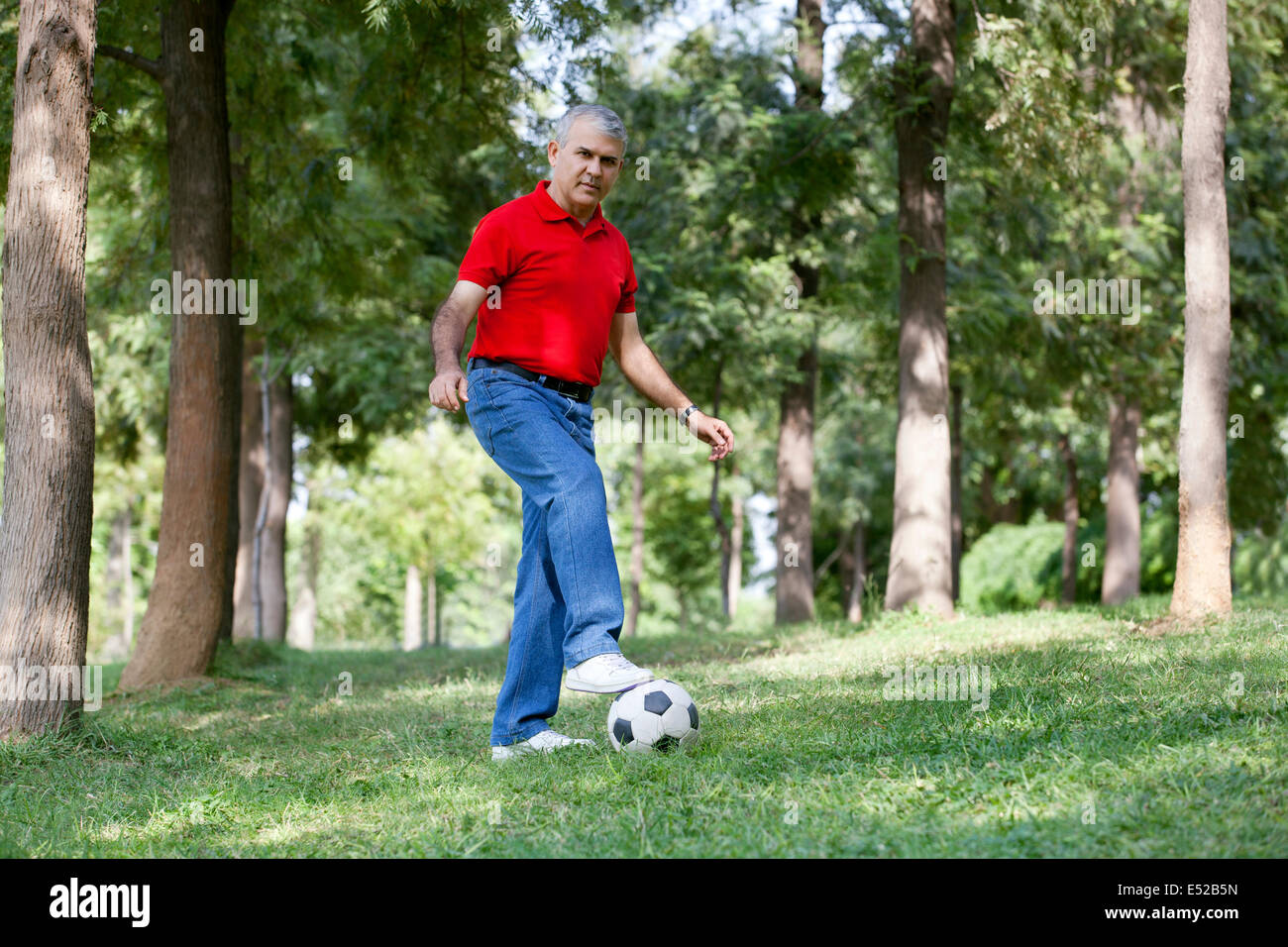 Portrait of a senior man playing soccer Stock Photo