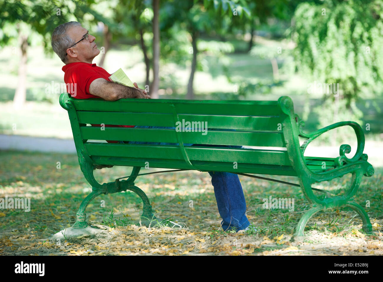 Senior man on a bench thinking Stock Photo