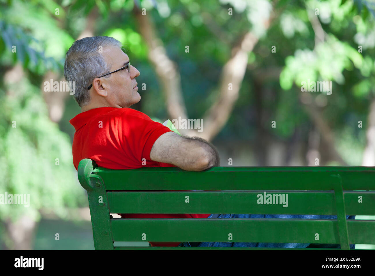 Senior man on a bench thinking Stock Photo
