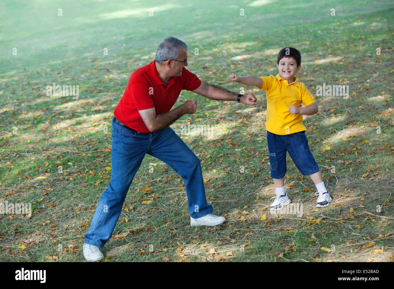 Grandfather having fun with grandson in park Stock Photo