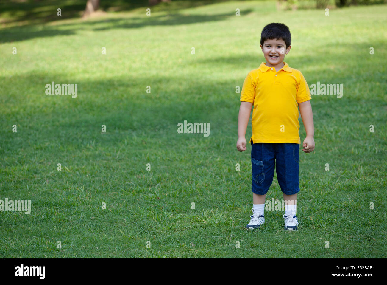 Portrait of a young boy in a park Stock Photo