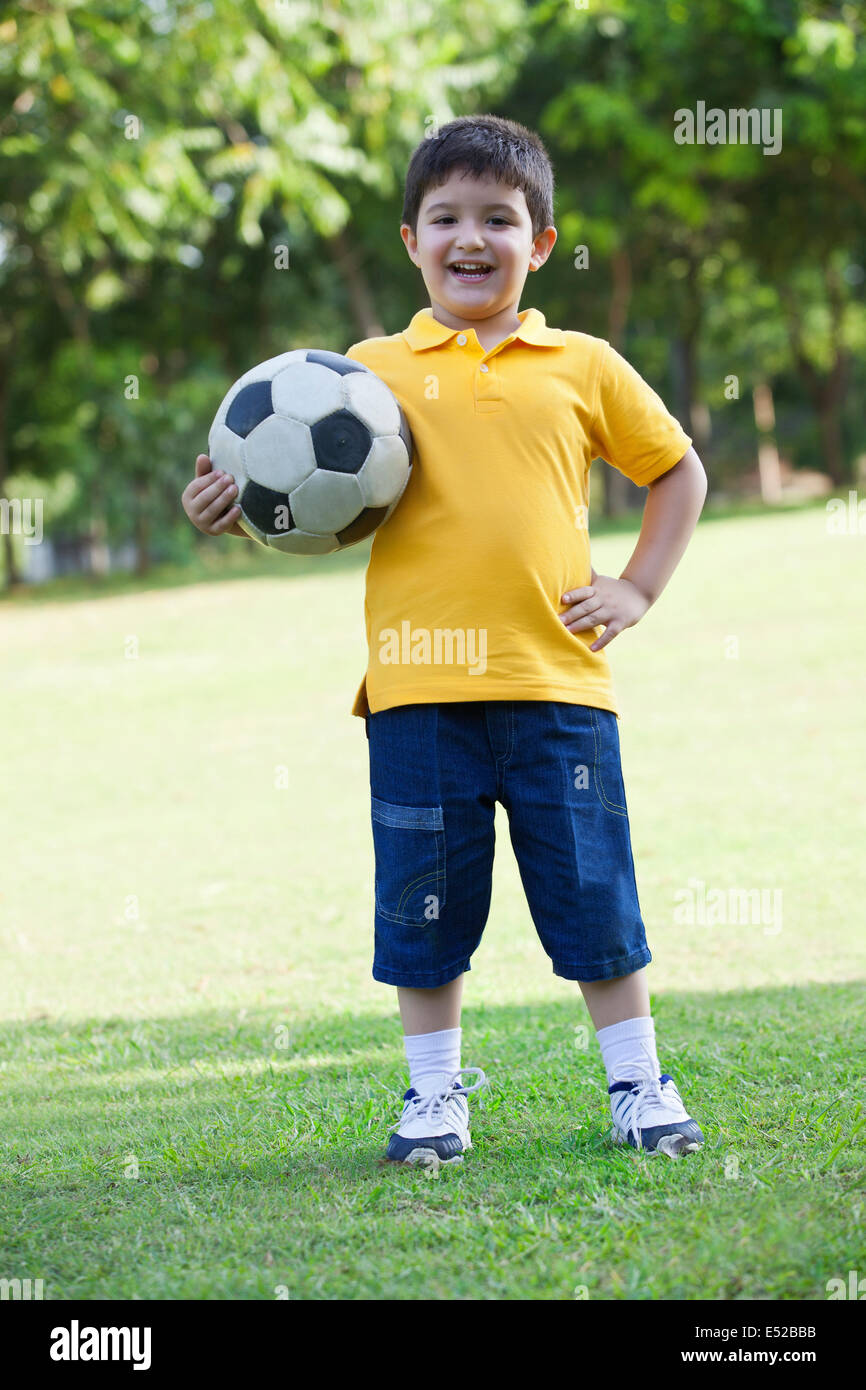 Portrait of a young boy holding a football Stock Photo