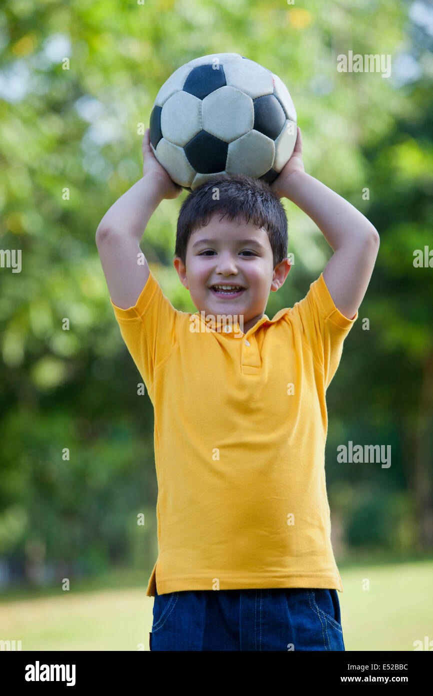 Portrait of a young boy holding a football Stock Photo