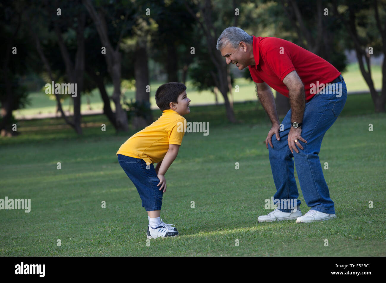Grandfather and grandson enjoying in a park Stock Photo