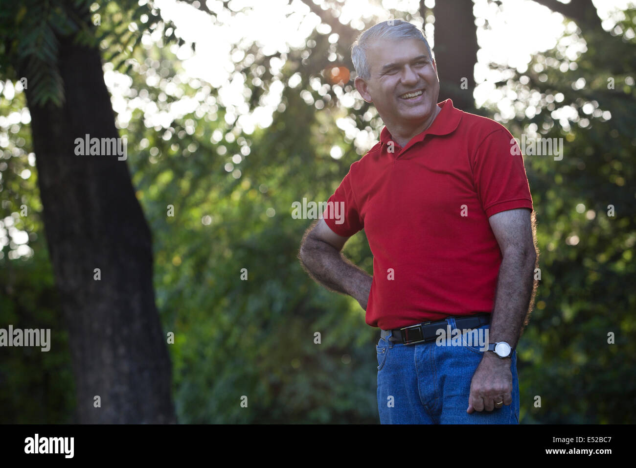 Senior man in a park smiling Stock Photo