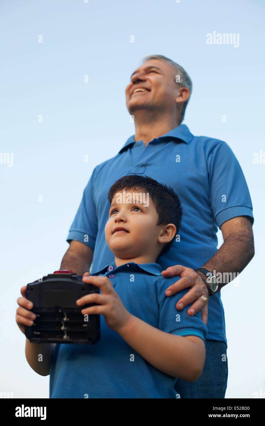 Grandfather and Boy Playing with Radio Controlled Handset, Stock Photo