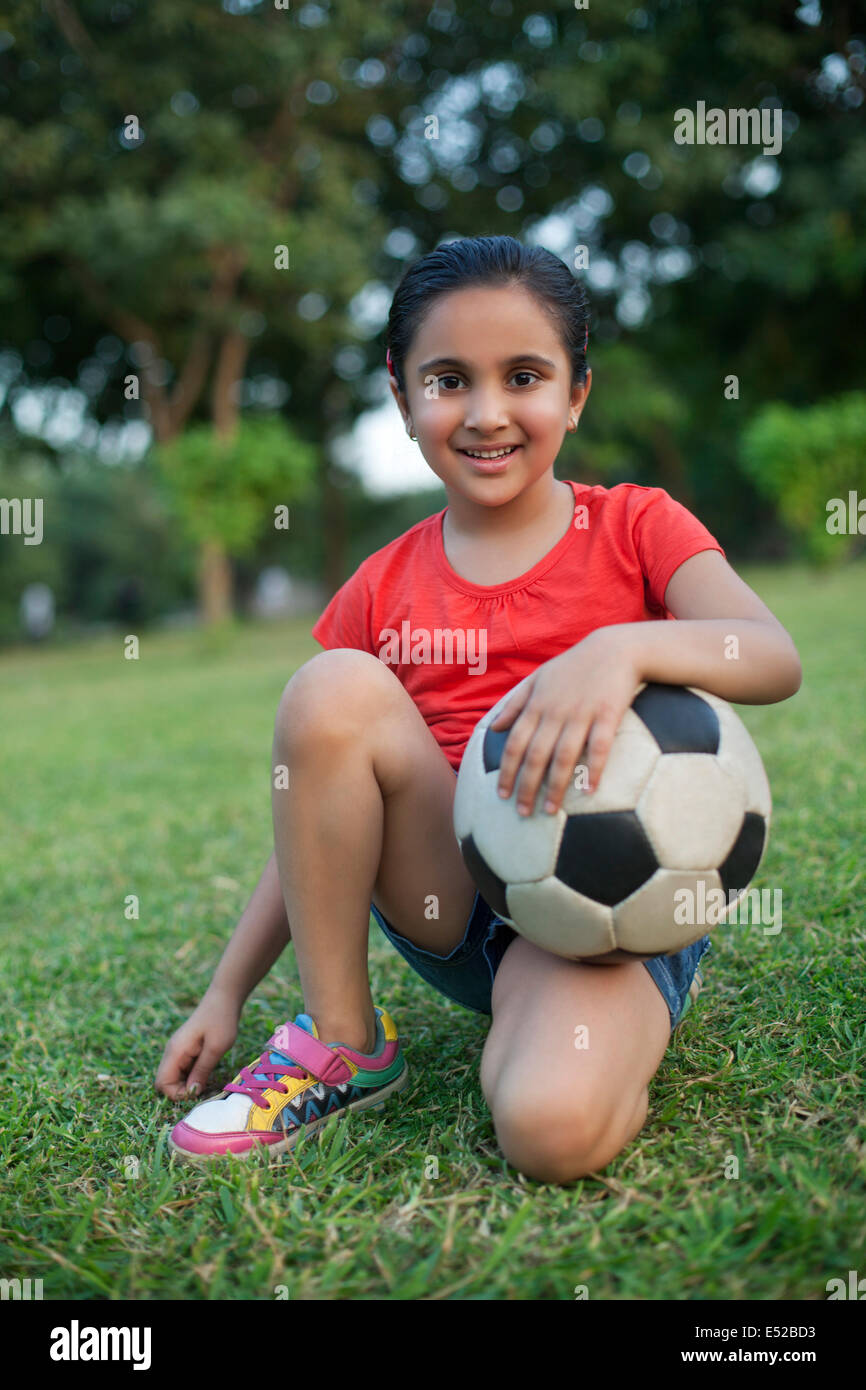 Portrait of a young girl holding a football Stock Photo