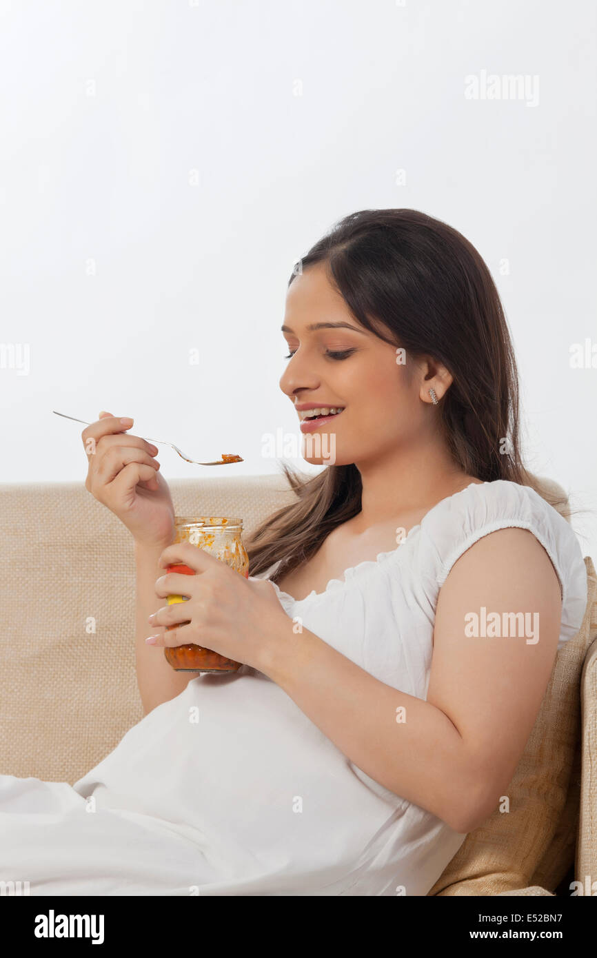 Pregnant woman eating pickle Stock Photo