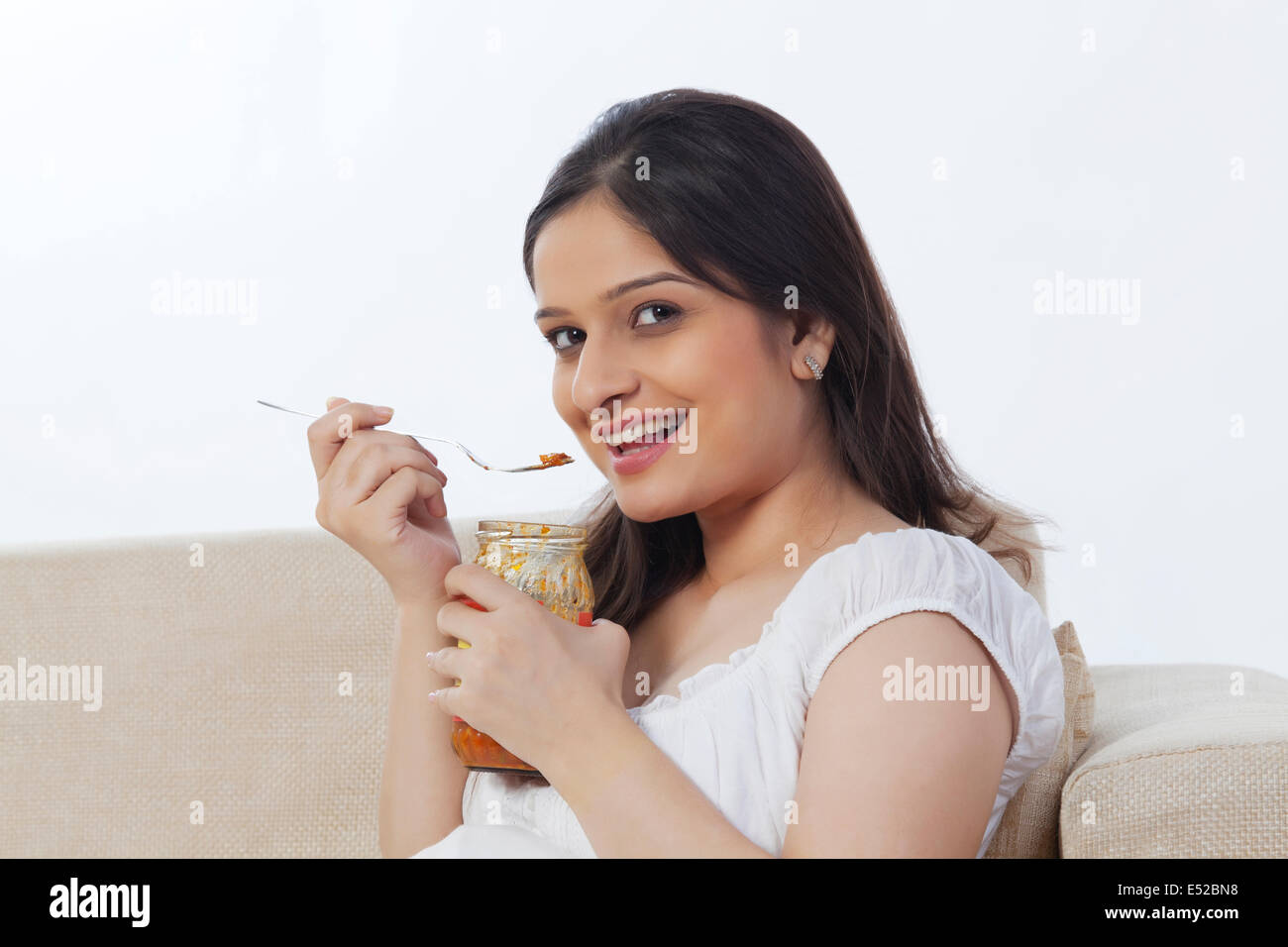 Pregnant woman eating pickle Stock Photo